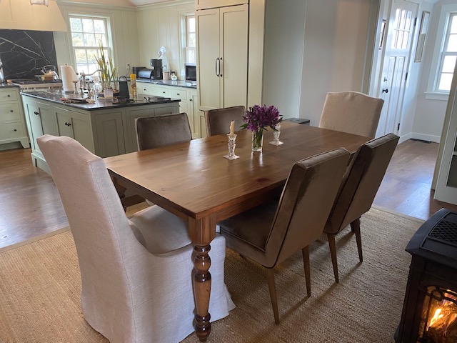 Solid wood dining table in Tobacco Leaf finish in customer dining area