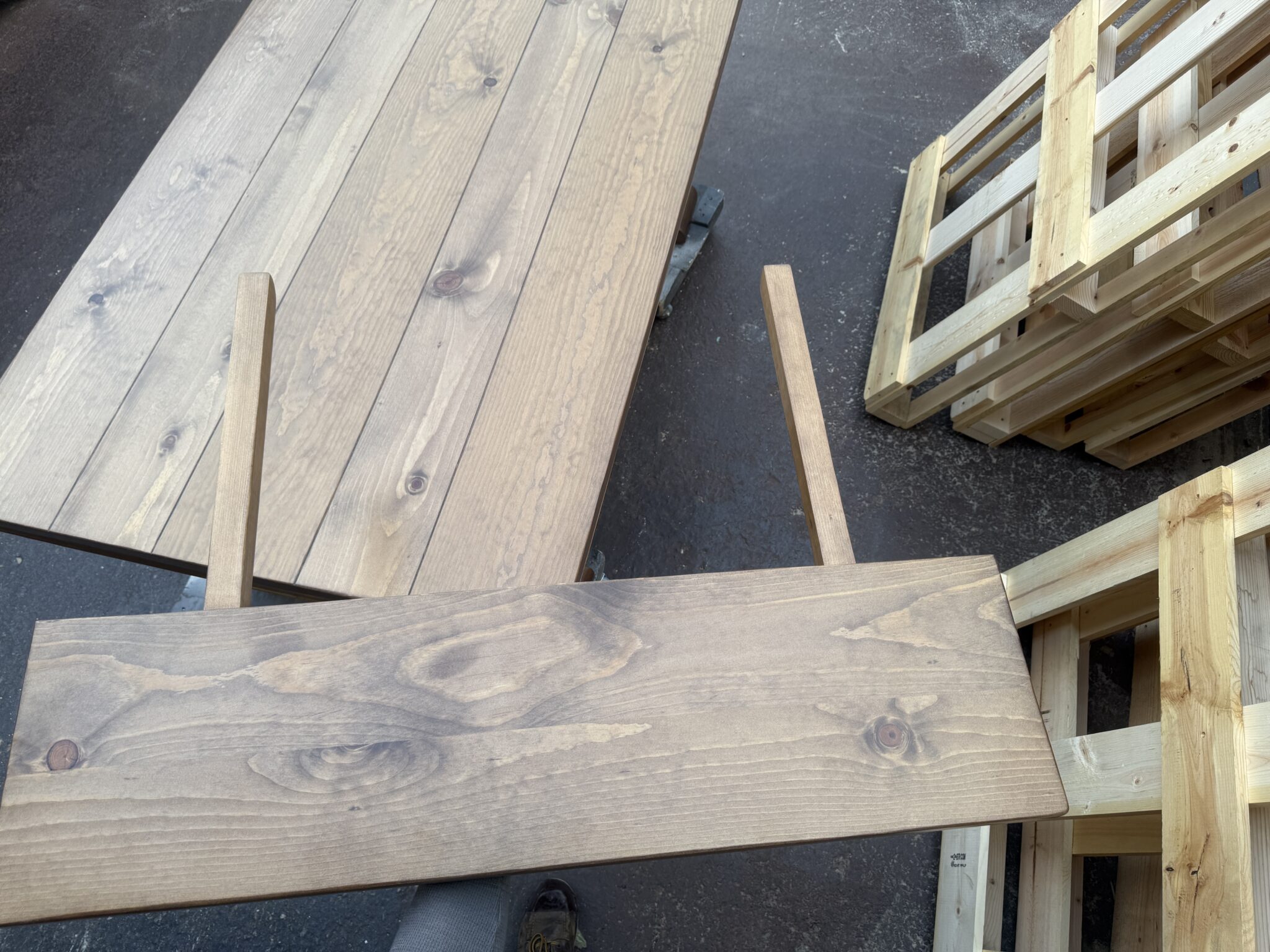 Detached breadboard extension with two wooden support arms attached underneath